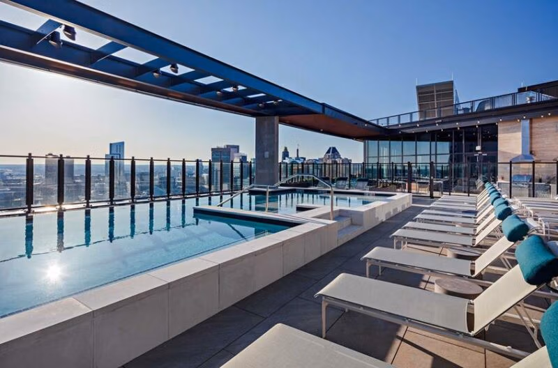 Rooftop pool and sundeck shown in a Hyatus Baltimore apartment listing